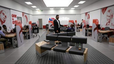 A man is in a large office filled with people, highlighting Capitec Bank's 2026 Internship Programme opportunities.