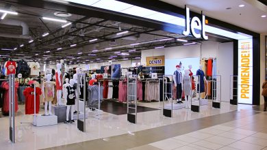 A vibrant store filled with clothing displays, advertising festive job openings at JET Retail Stores for the holiday season.