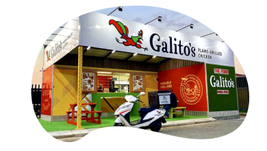 A parked scooter is seen outside a restaurant advertising career openings with the slogan "Ignite Your Career."