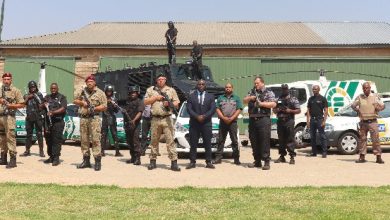 A group of soldiers smiles for a photo in front of a building, showcasing Fidelity Services Group's Youth Learnership initiative.