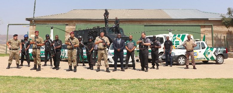 A group of soldiers smiles for a photo in front of a building, showcasing Fidelity Services Group's Youth Learnership initiative.
